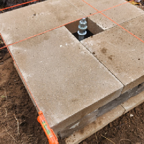 auger surrounded by paver stones