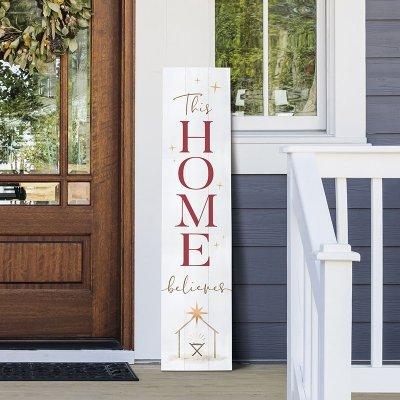 leaning porch sign with manger: This home believes