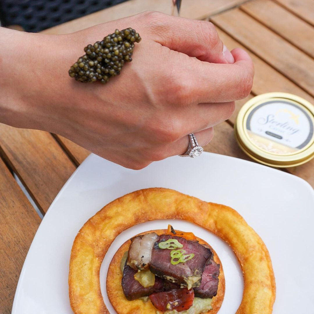 Caviar bump of Supreme Caviar on a woman's hand