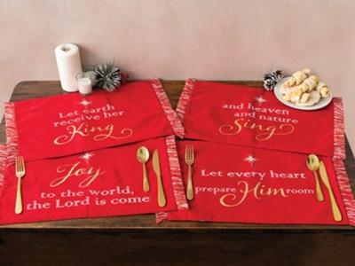 Red placemats with gold lettering with words from Joy to the World