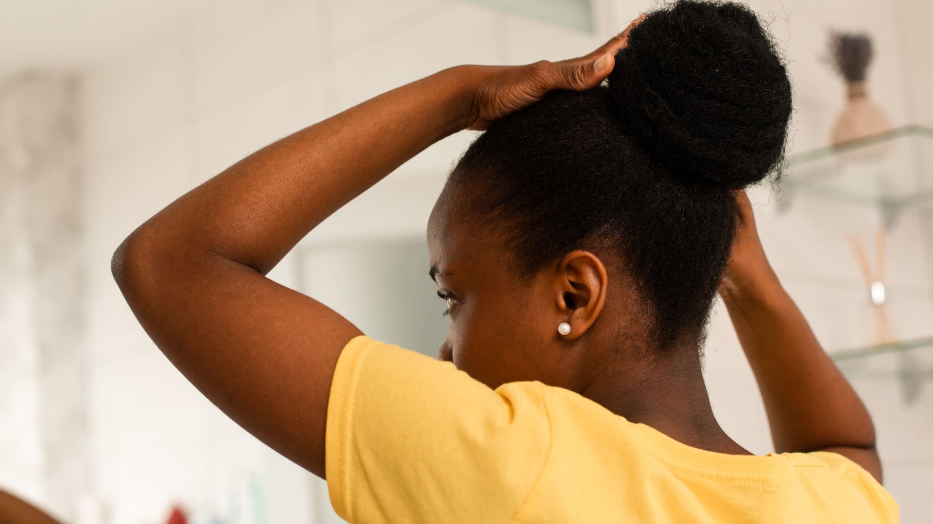 black woman combing her natural hair