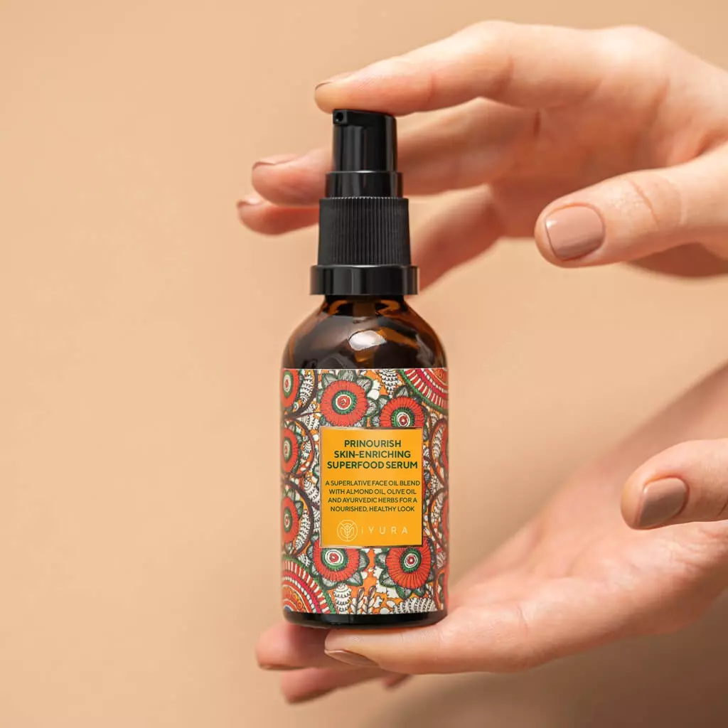 Two hands holding a bottle of Prinourish