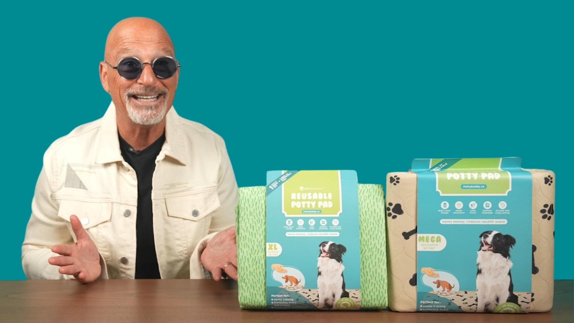 Two dogs using Potty Buddy reusable pee pads in a living room