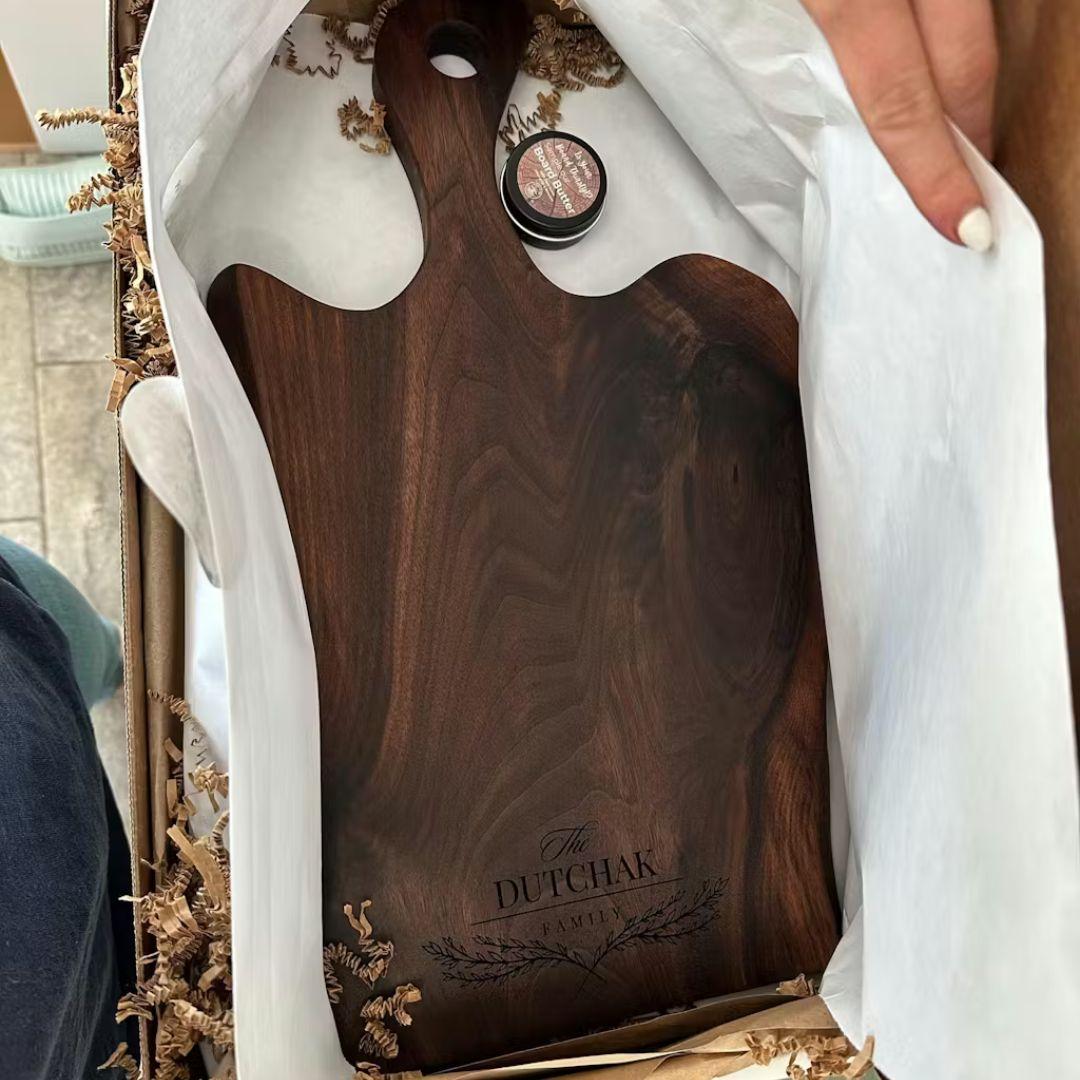 Customer review photo of personalized live edge walnut charcuterie board engraved as a wedding gift
