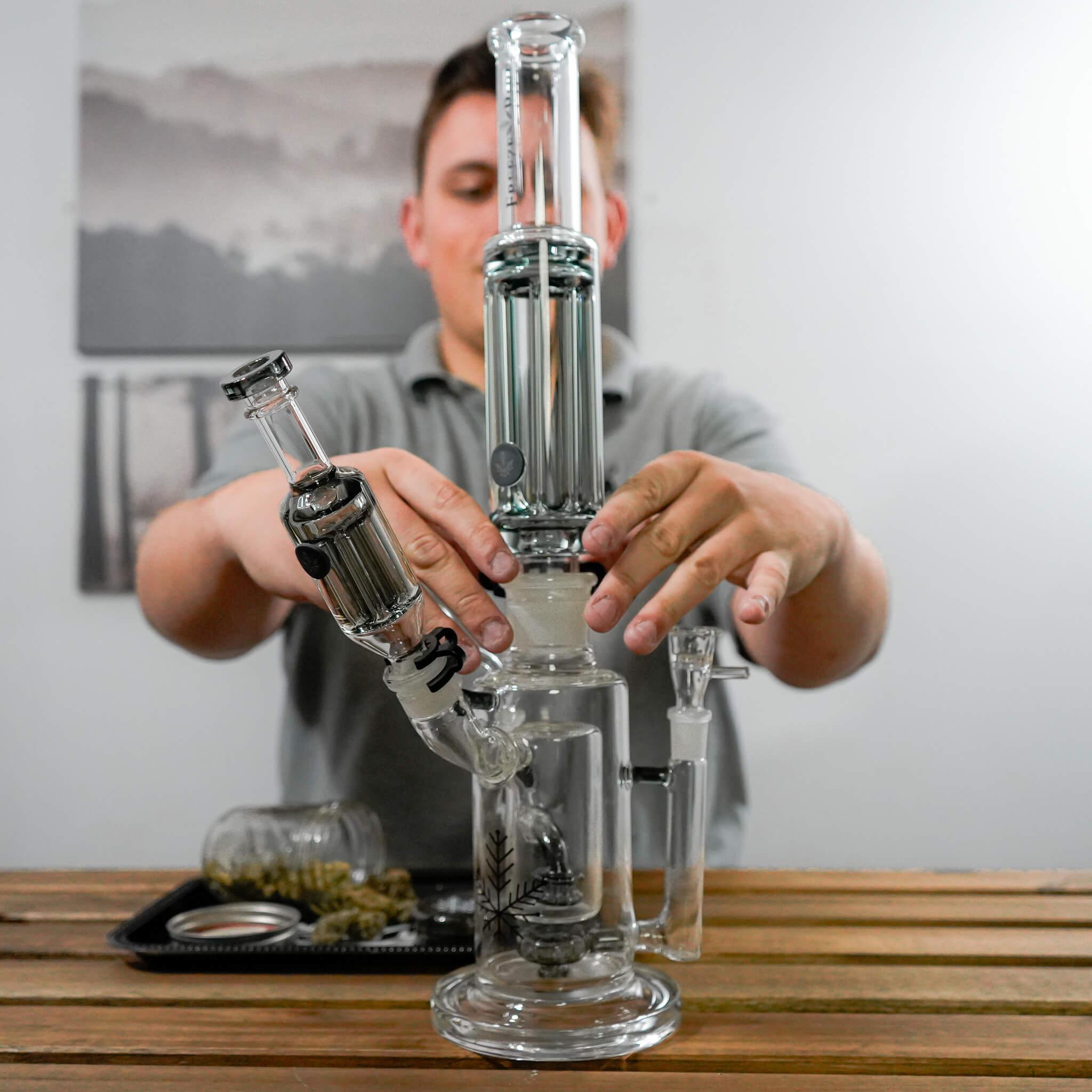 hands passing glass inside out bong