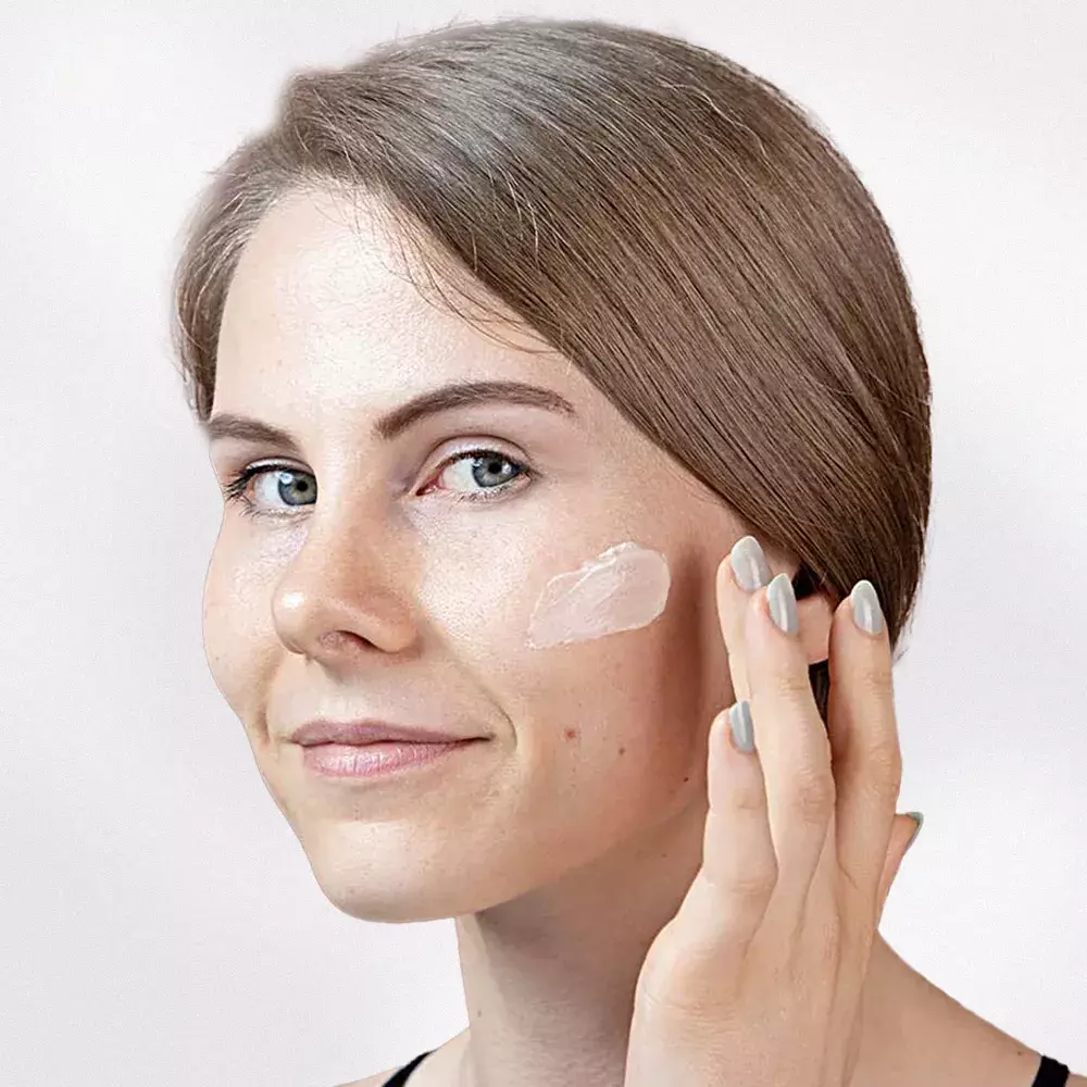Woman applying Cerabuild Face and Neck Cream on her face