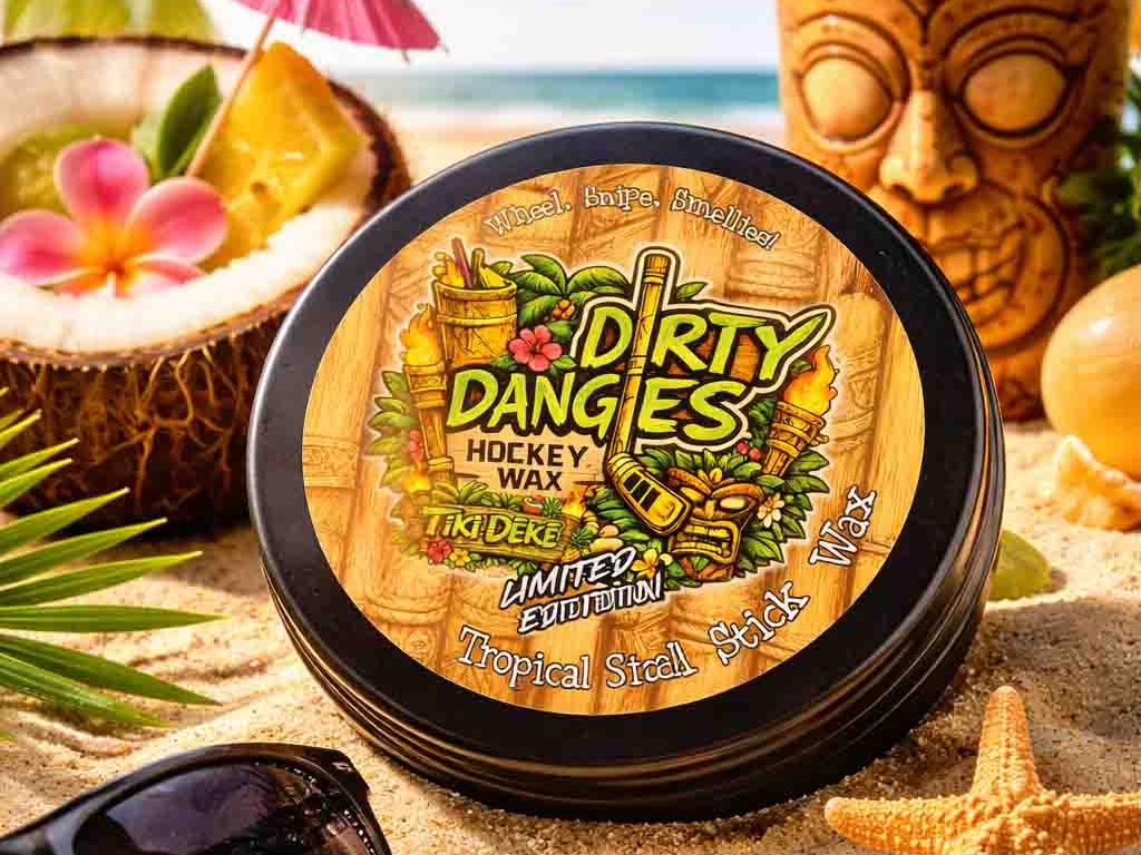 A tin of dirty dangles tiki deke limited edition tropical stick wax on a beach with tiki drinks and sea shells.