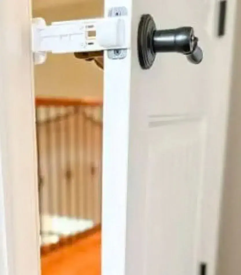 Door Buddy Cat Door Prop mounted using a door's existing strike-plate holes