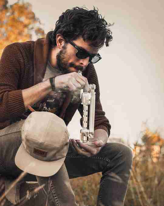 person smoking weed with water bong