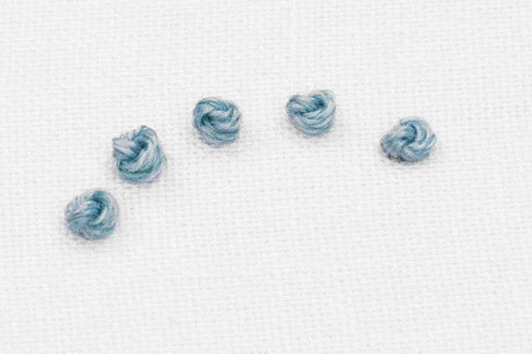 5 French Knots have been created in the fabric.