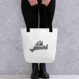 A lady holding a white tote bag