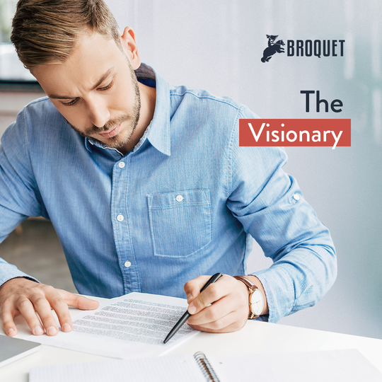 man holding a pen and looking at a piece of paper on a desk, broquet logo, text reads: the visionary