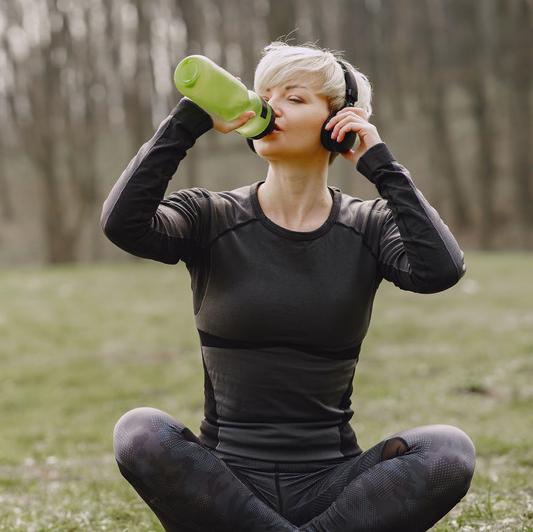 Woman outside drinking water