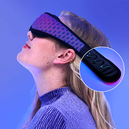 A blonde girl wearing a sleep mask for stomach sleeping with the grippy gel of the strap zoomed in.