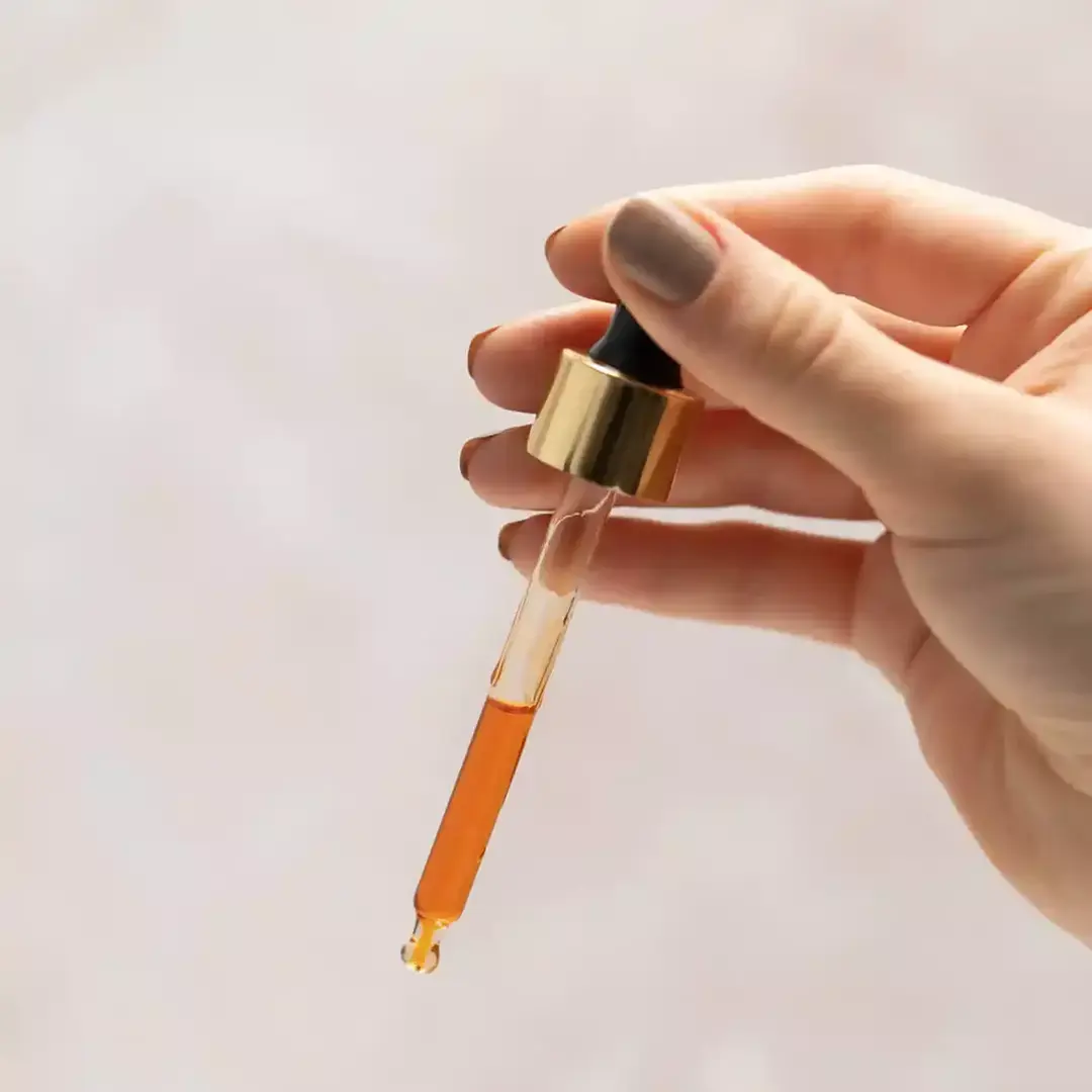 A glass dropper with manjish glow elixir serum