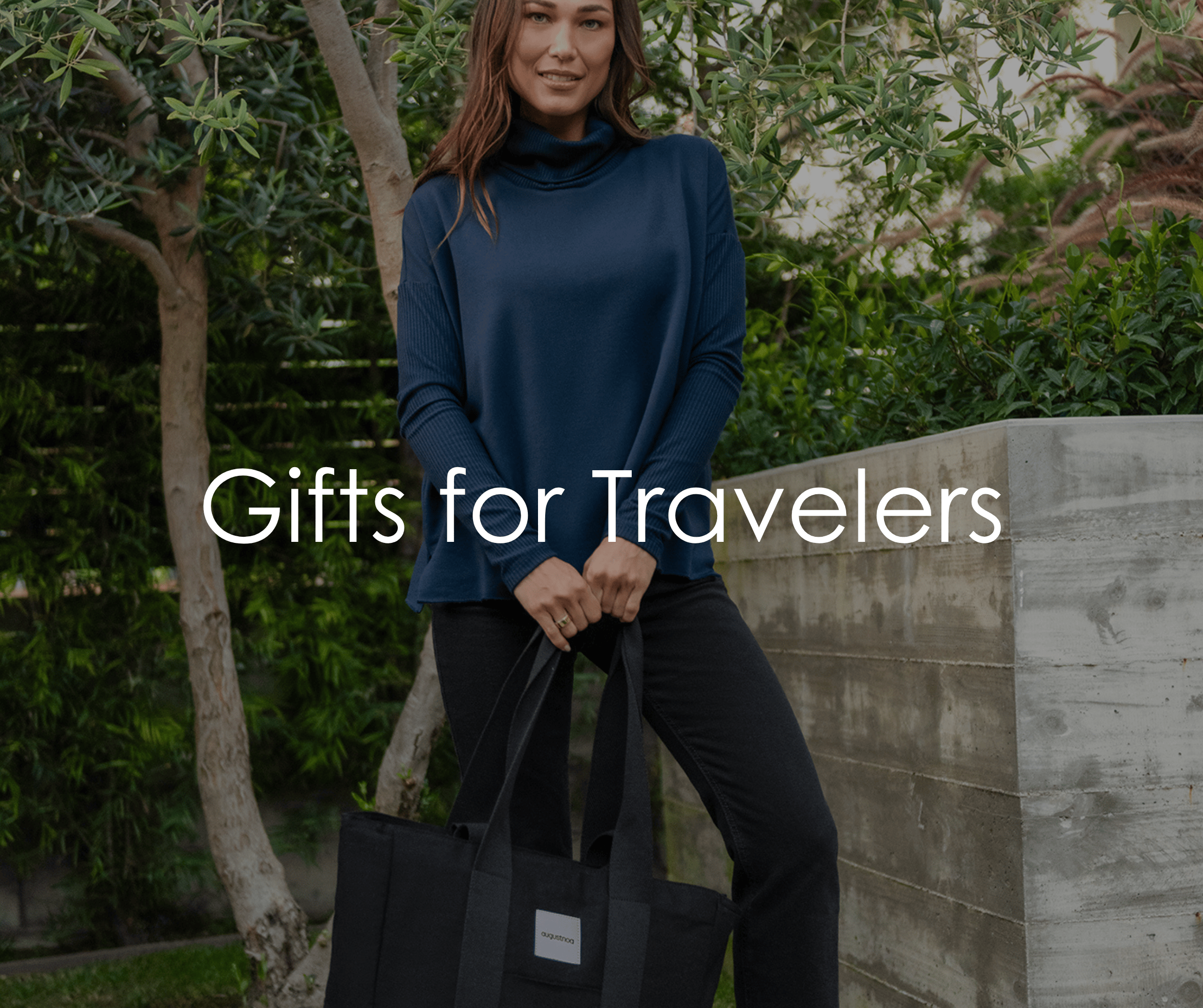 female holding a tote bag outside