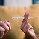 womans hands holding a one hitter
