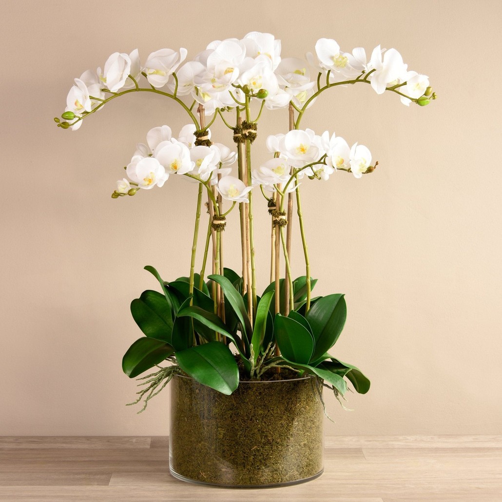 Faux white orchid arrangement in matte gold planter