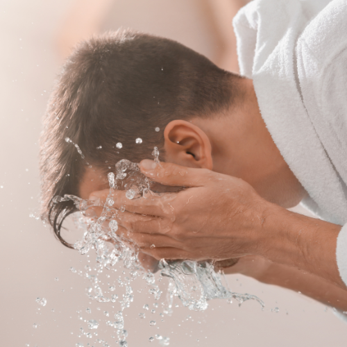 Man Washing his face