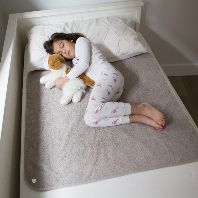 Girl sleeping on the bed covered with PeapodMat