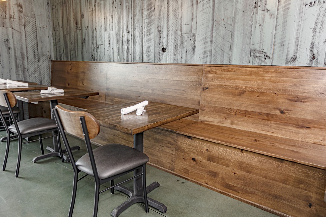 teal barnwood wall with reclaimed banquette seating