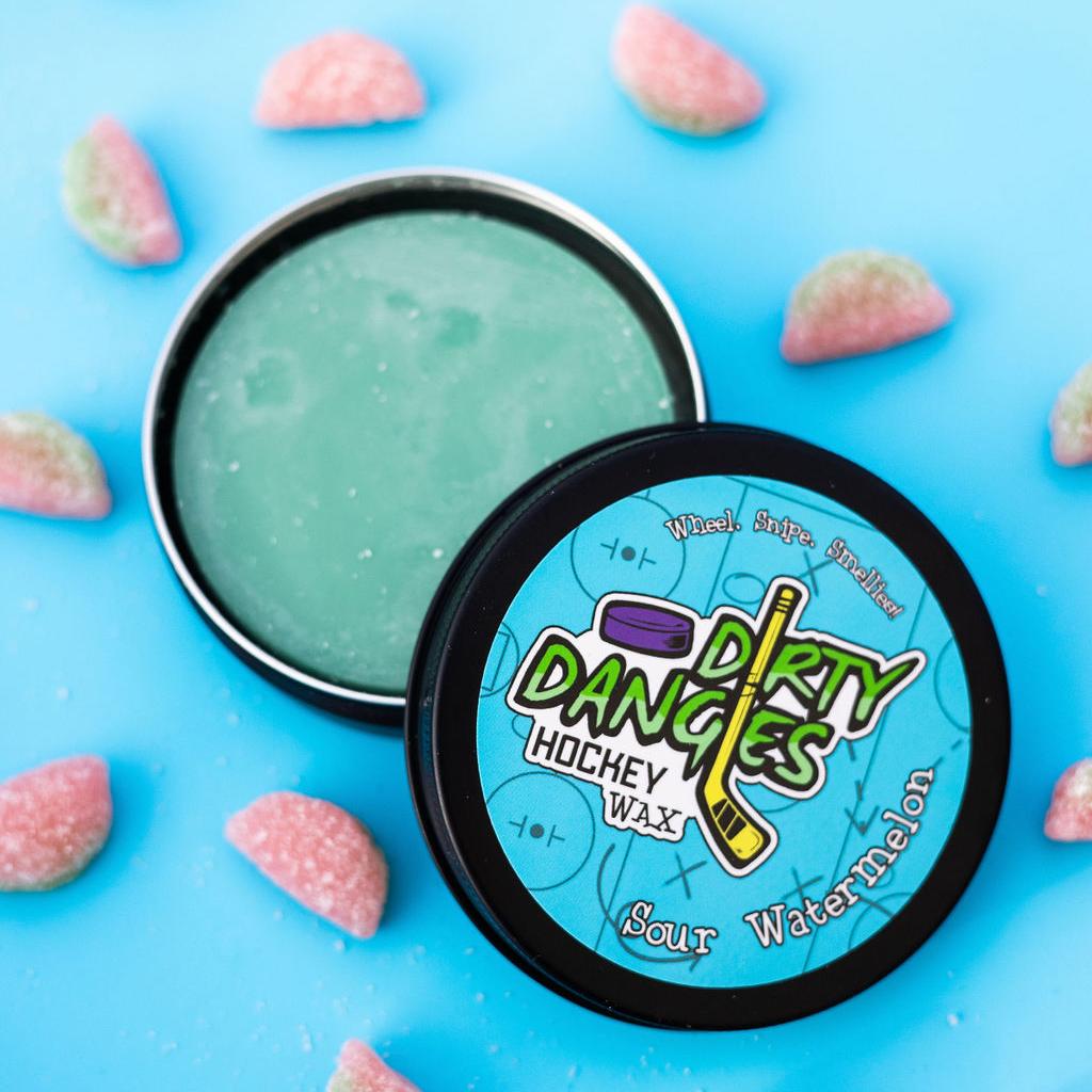sour watermelon scented hockey stick wax on a blue background with sour watermelon candies