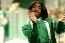 GIF of Andre 3000 from the band Outkast clapping during the music video to "Hey Ya"