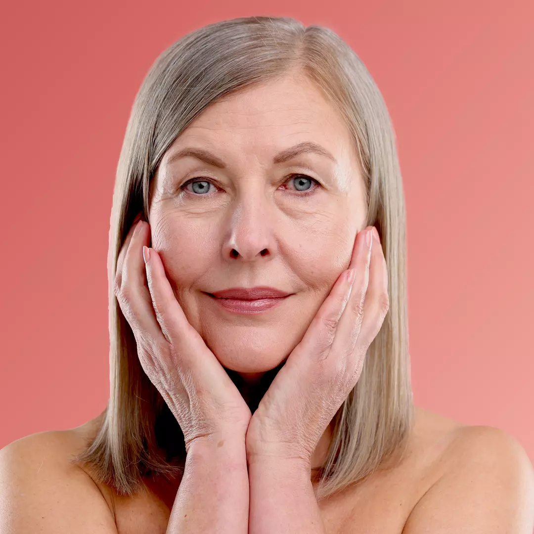 Women touching face after applying blavana face pommade