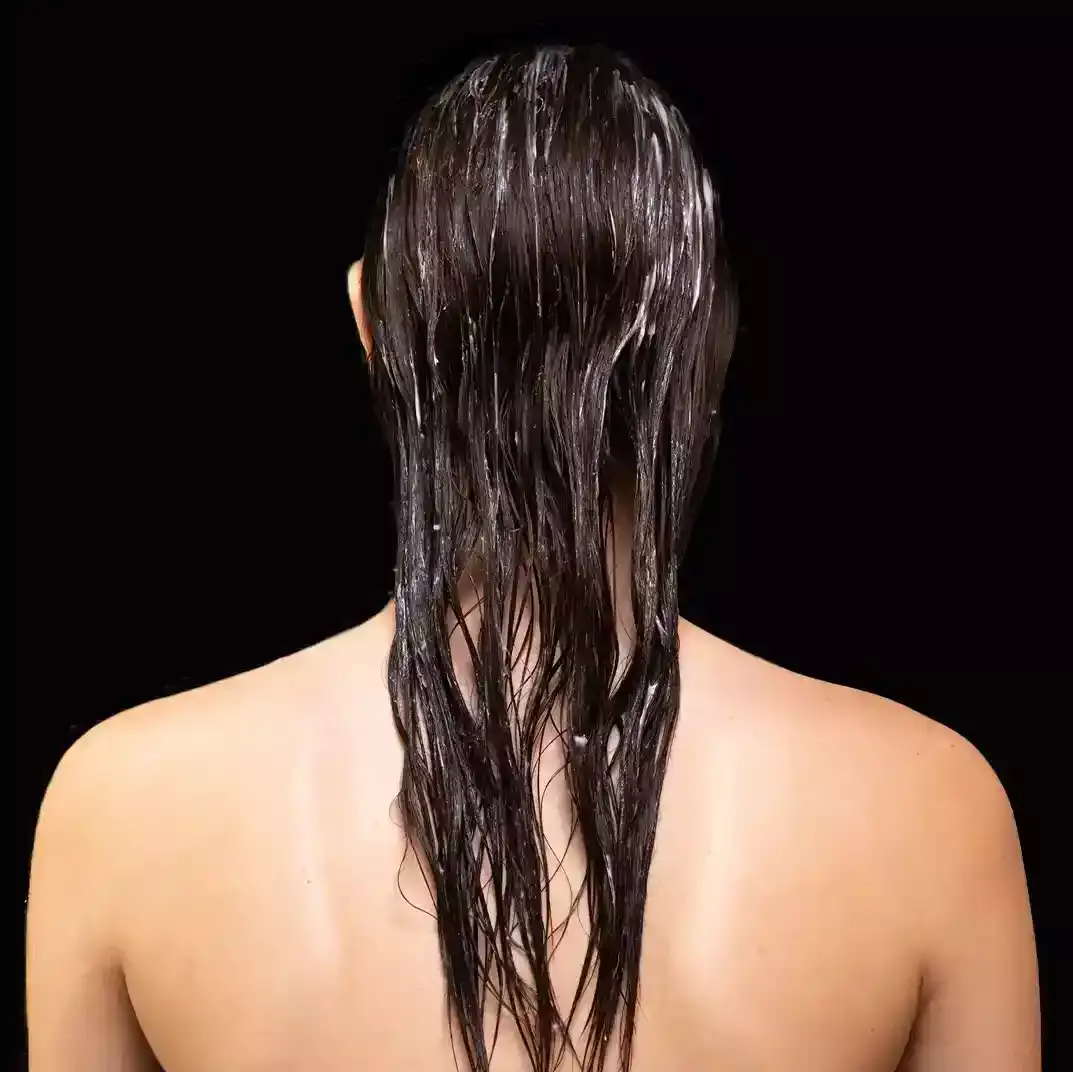 Woman with hair mask applied on scalp
