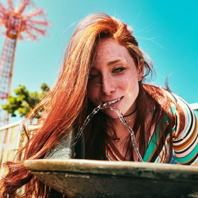 Girl drinking from water fountain