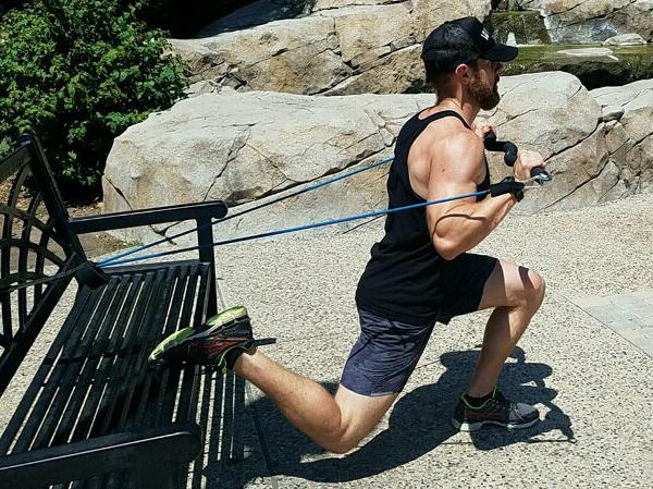 man using xbar performing a lunge and chest press