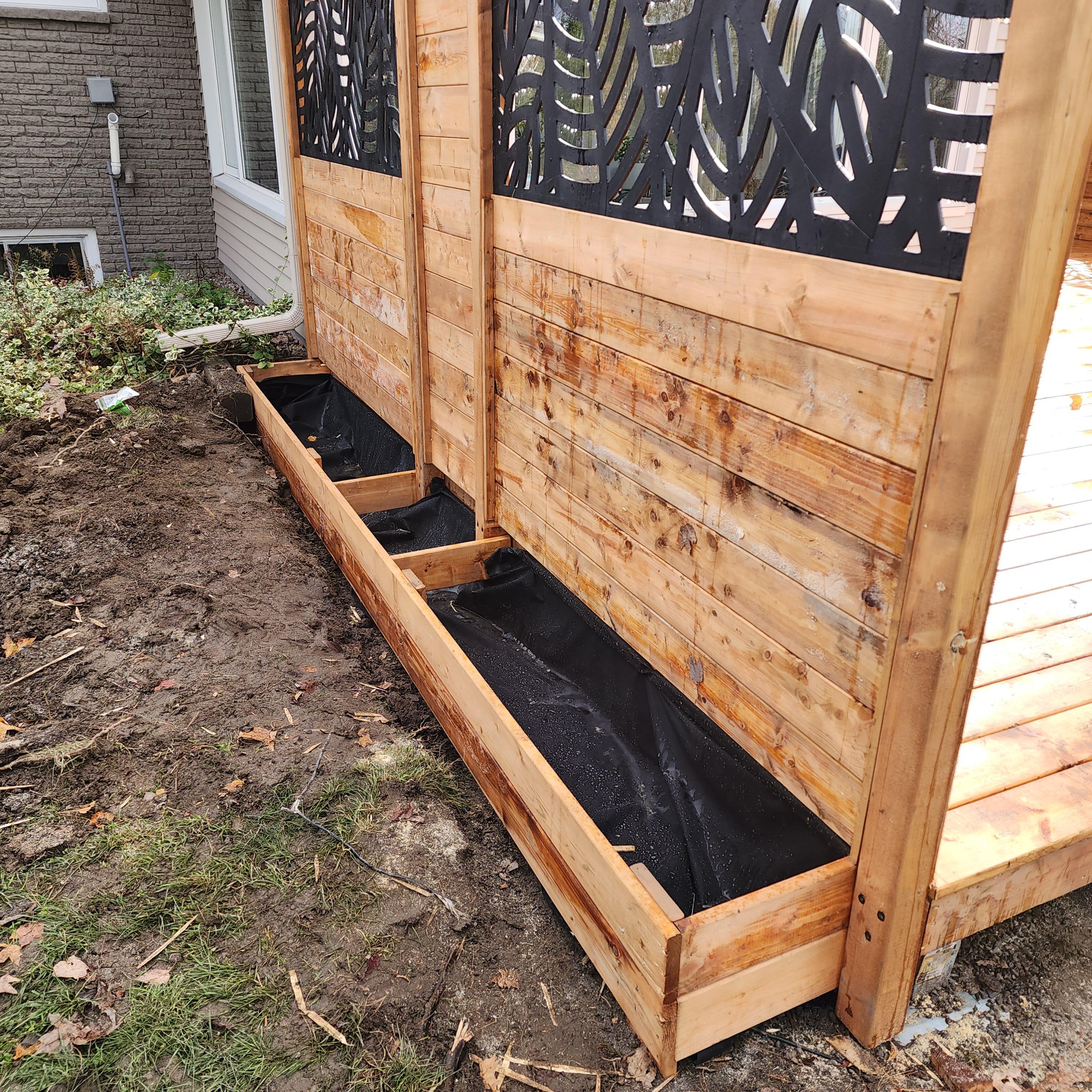 Close up of wooden planters installed on the other side of the privacy wall.