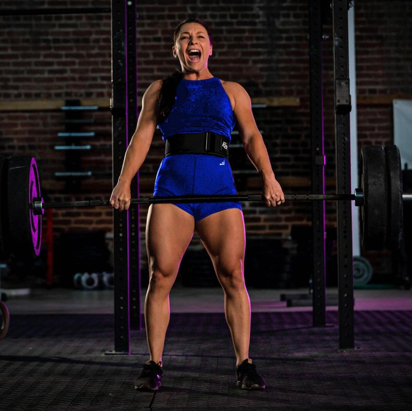 Man squatting with barbell with weights attached