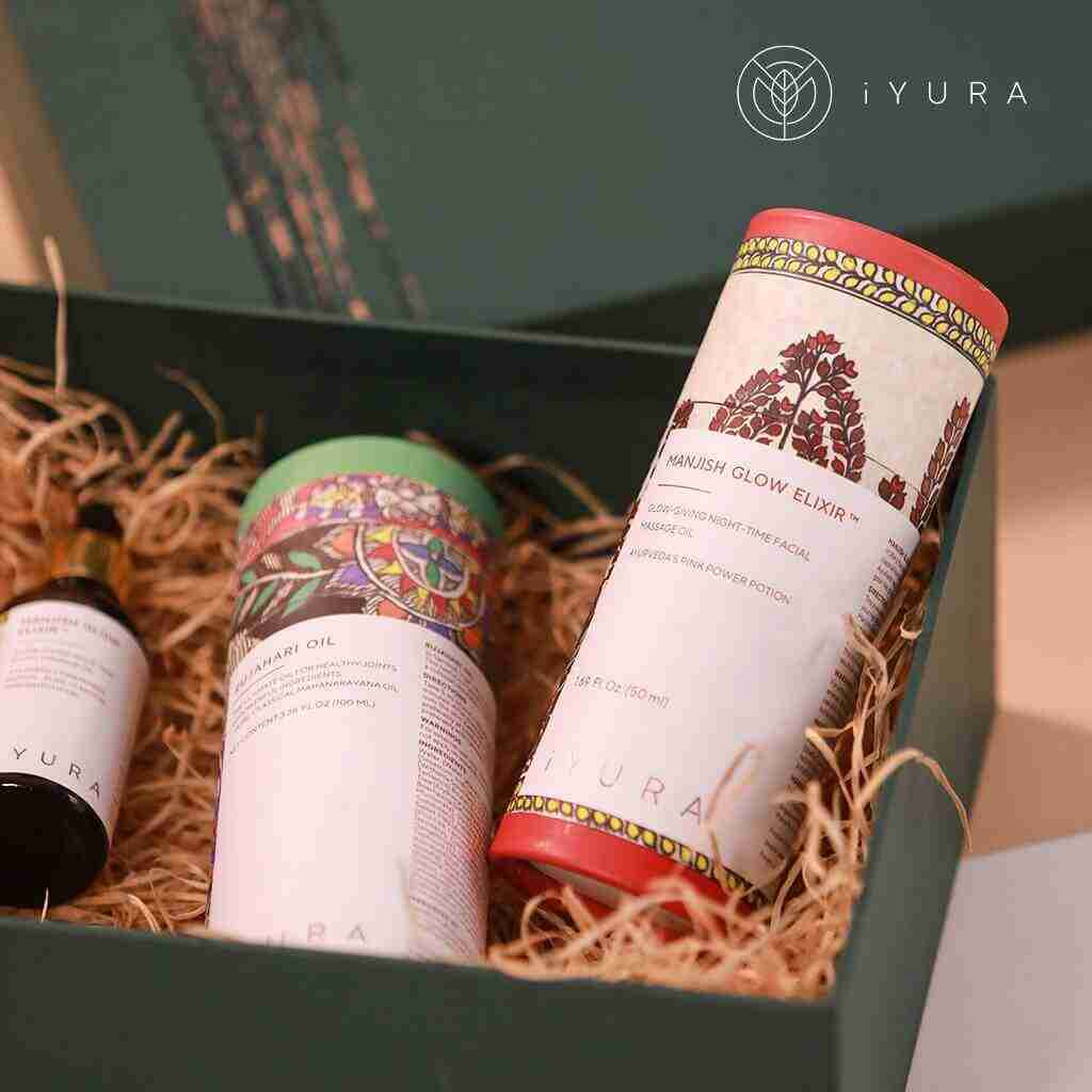 Manjish Glow Elixir and other iYURA products showing off their beautiful packaging with Madhubani painting