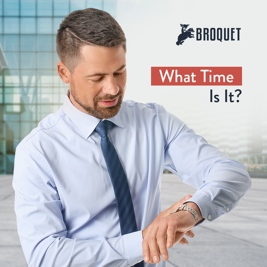 man looking at his wristwatch, broquet logo, text reads: What time is it?