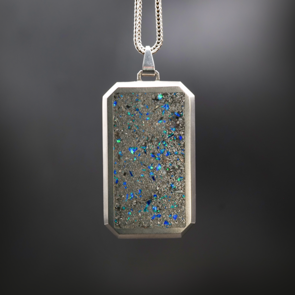 The Star Dust Glowstone Pendant is a glow in the dark pendant, filled with meteorite shavings, crushed bello opal, diamonds, and moonstone
