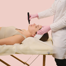 woman lying down while having micro needling done on her face