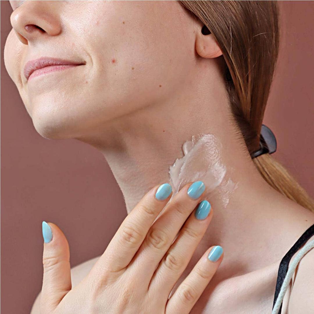 Model applying cerabuild cream on neck