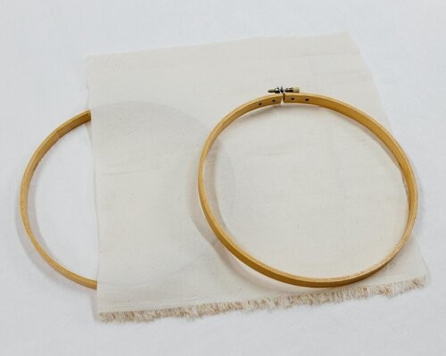 This image shows step 1 of dressing your hoop, pulling the two hoop pieces apart.