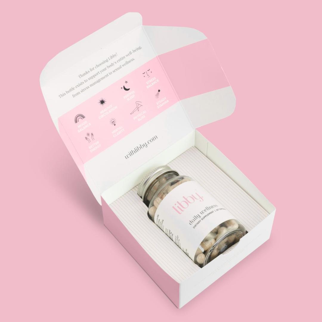 Bottle of Libby capsules in its packaging on a pink background.