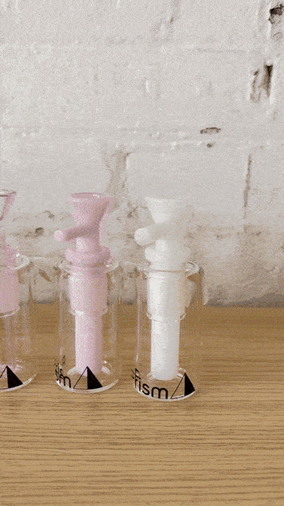 A rotating display of Prism Modular Ash Catchers in 14mm/45-degree and 14mm/90-degree angles. The GIF showcases a full array of colors and sizes, highlighting the dual-function wet and dry filtration options available for beaker bases, straight tubes, and honeycomb bongs.