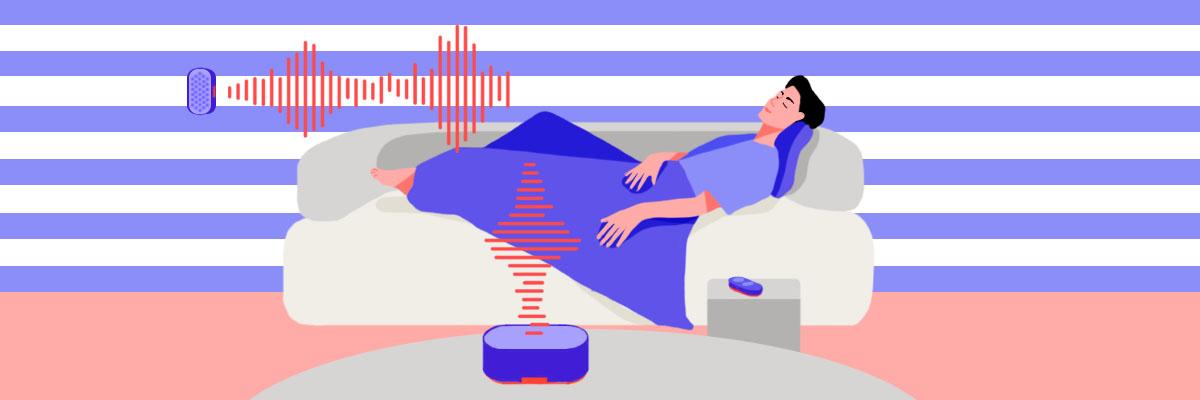 A relaxed man lying down on the couch, using a white noise machine, listening to white noise for tinnitus relief.