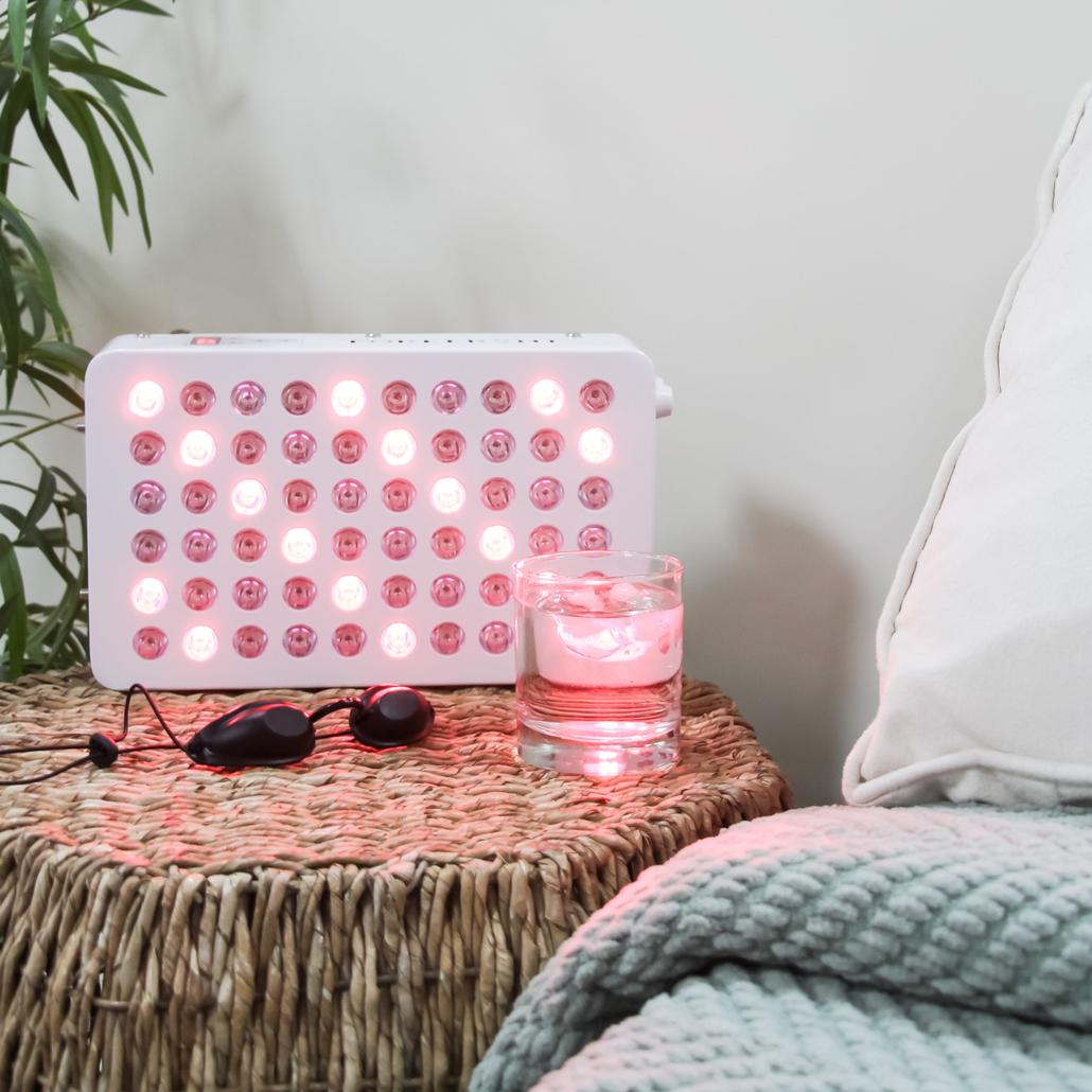 Portable Red Light Therapy Device set on a bedside table
