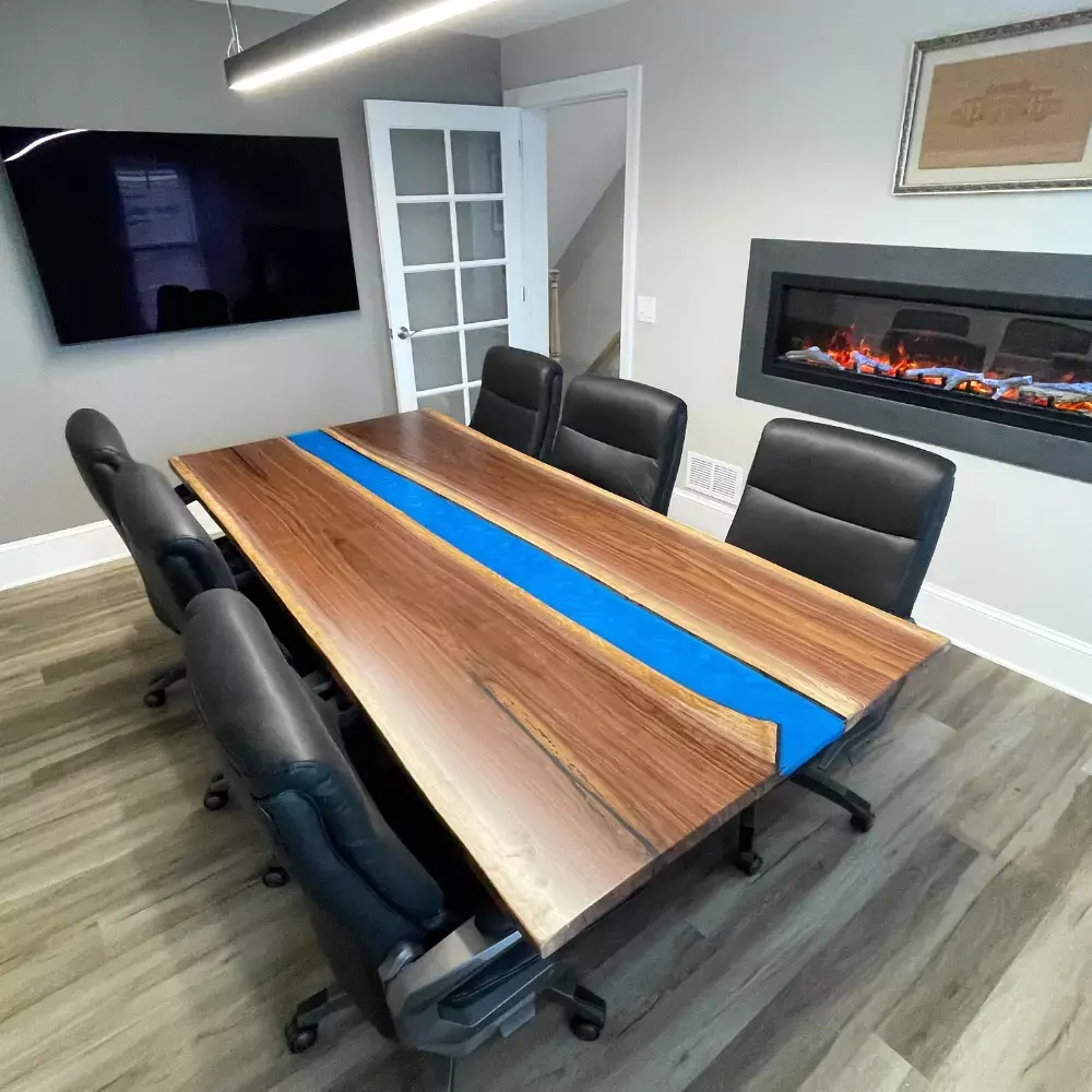 Live edge walnut blue river conference table in modern office with leather chairs and fireplace