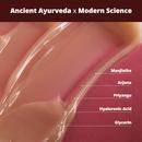 Close-up of a smooth, creamy gel-cream texture with labeled key ingredients: Manjistha, Arjuna, Priyangu, Hyaluronic Acid, and Glycerin. Headline reads: Ancient Ayurveda x Modern Science.