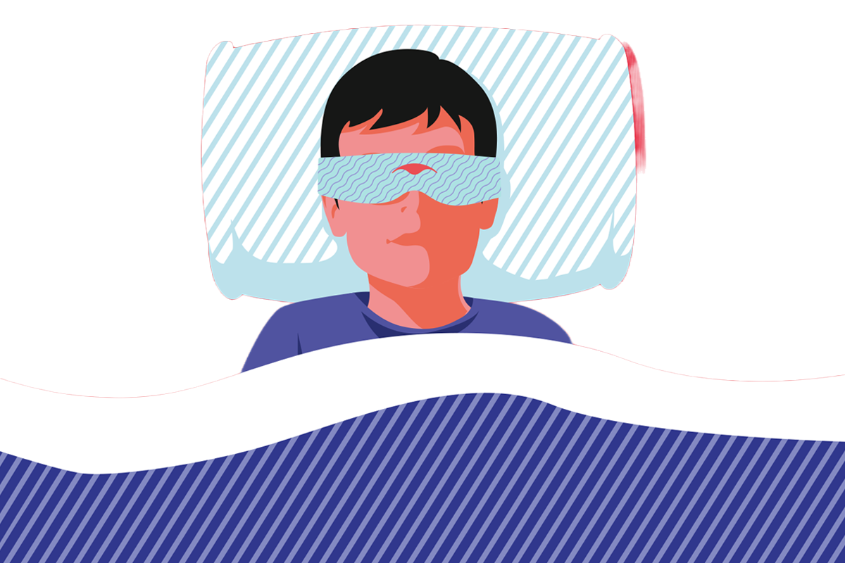A child sleeping in bed wearing a sleep mask for boys.