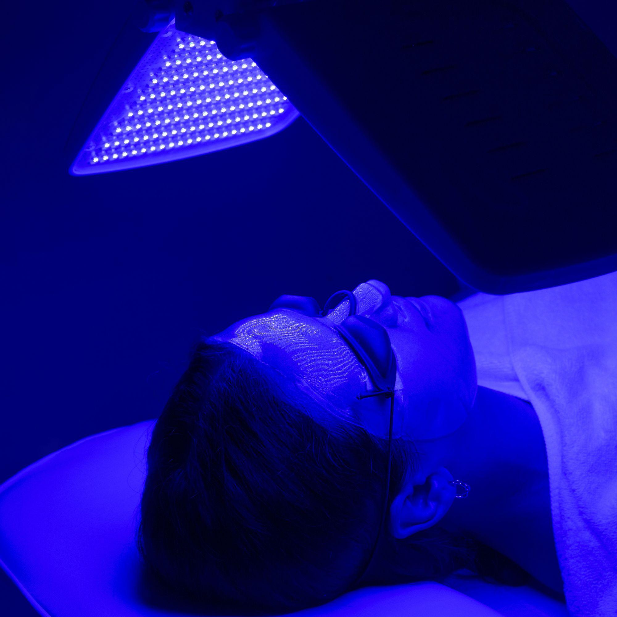 Woman getting blue light therapy