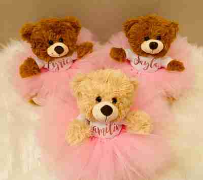 Three bears dresseed in pink tutus