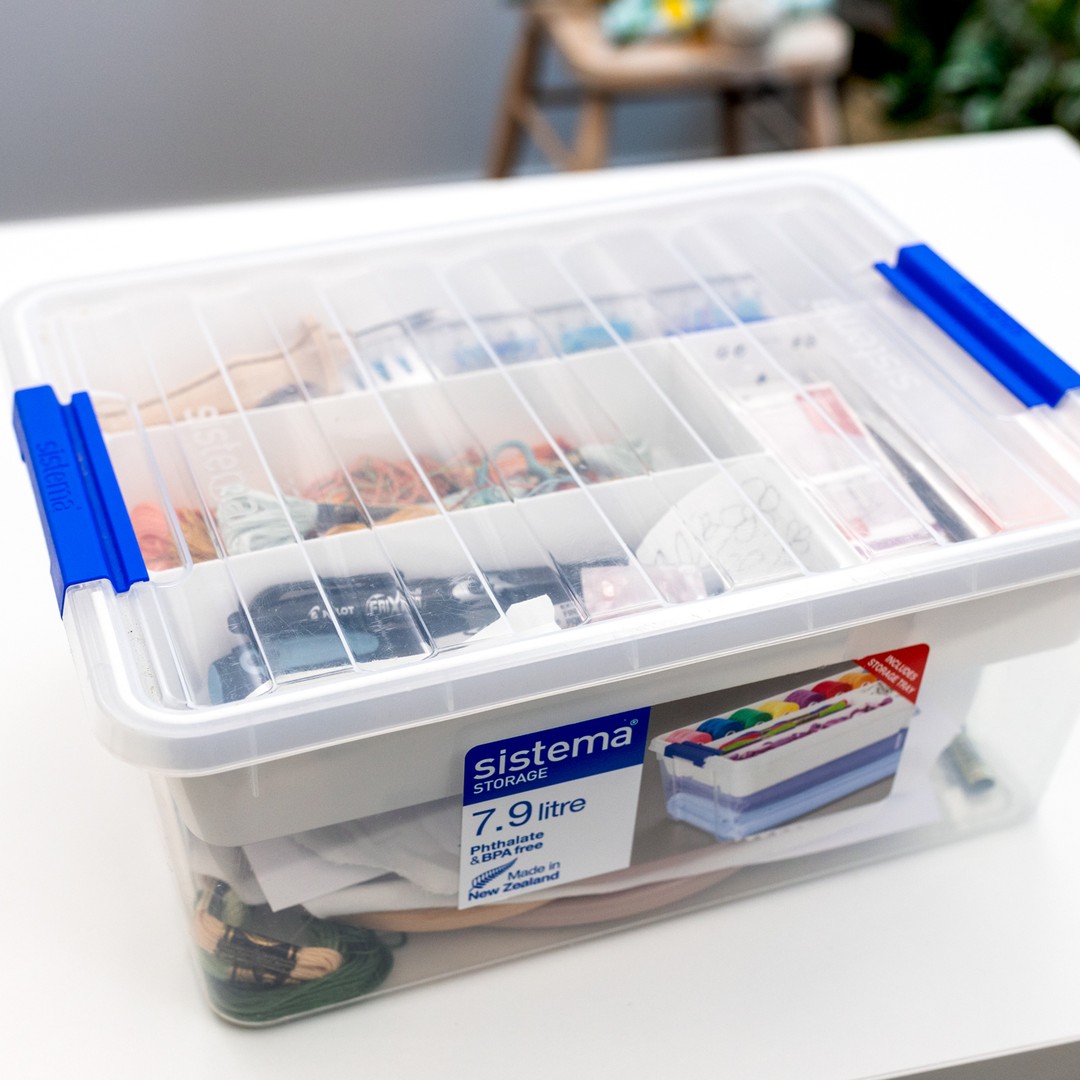 This is an image of a plastic project container with supplies inside for working on embroidery projects.