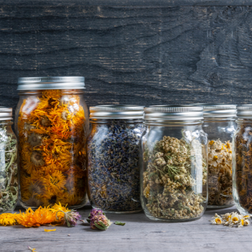 Jars of various herbs representing a blend of natural ingreditents